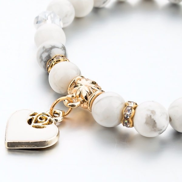Gold heart charm on a white marble bead bracelet
