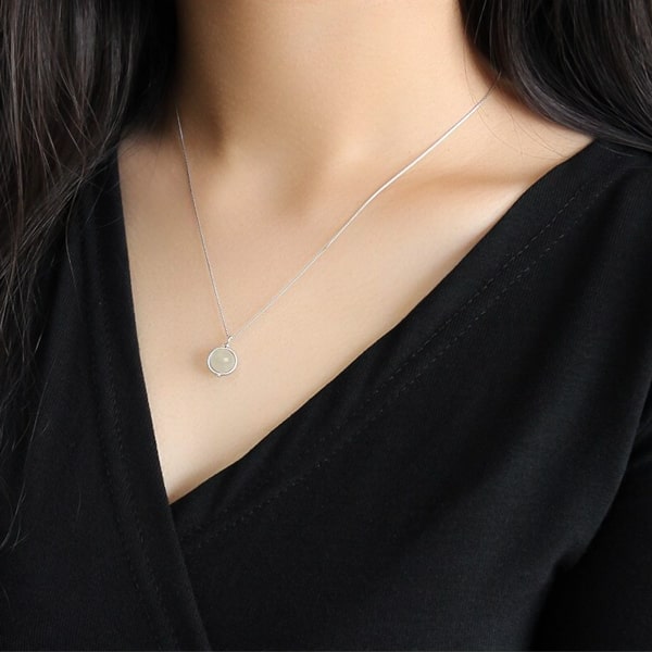 Woman wearing a white moonstone pendant necklace