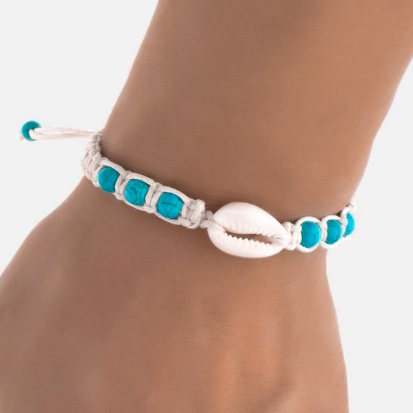 Woman wearing a white and turquoise shell bracelet