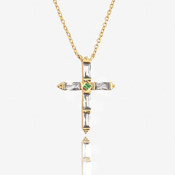White crystal cross on a gold necklace details