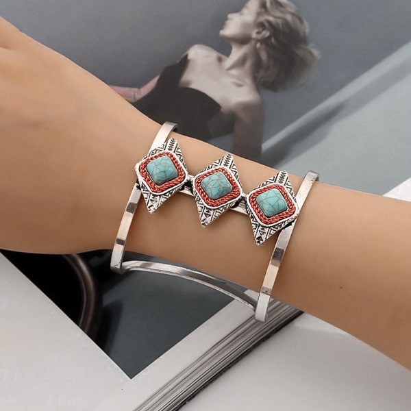 Woman wearing a wide silver and turquoise Aztec cuff bracelet