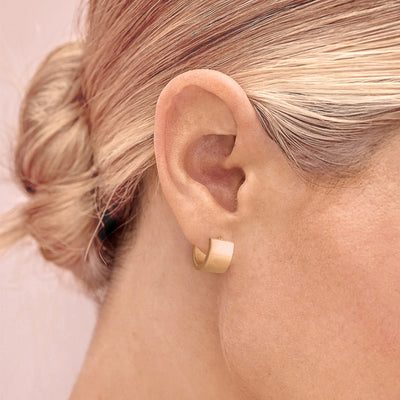Wide gold mini hoop earrings
